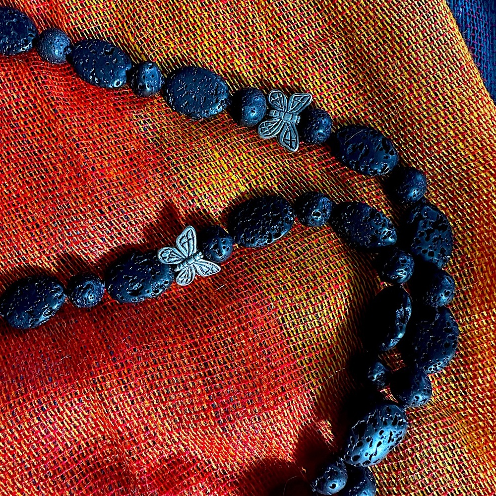 Lava bead necklace 50 inches long and 2 silver tone butterfly beads